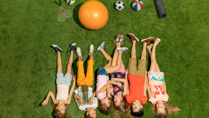 Group Of Happy Children Playing Outdoors.