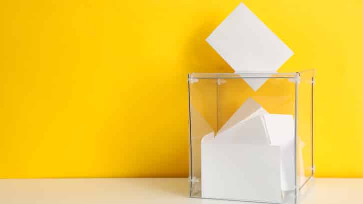 Voting Box With Bulletins On Yellow Background, Space For Text